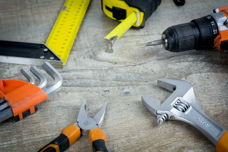 A set of tools spread across a table, ready for a home repair