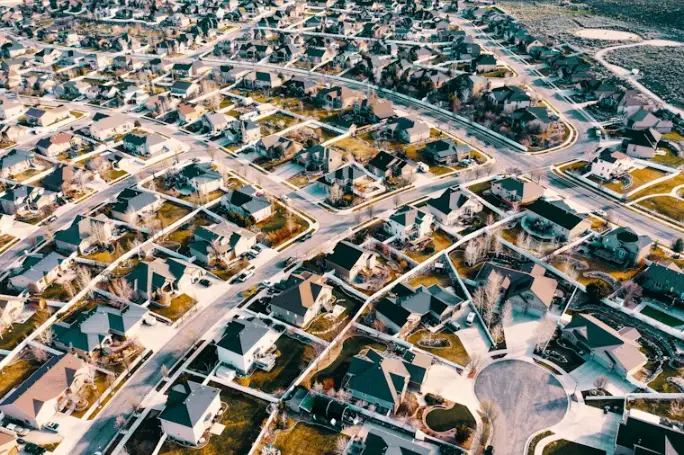 Aerial photo of a city with buildings, roads and green trees