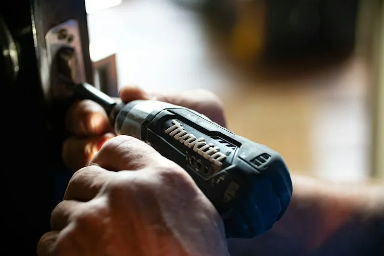Blue and black cordless power drill in close focus, ready for a repair