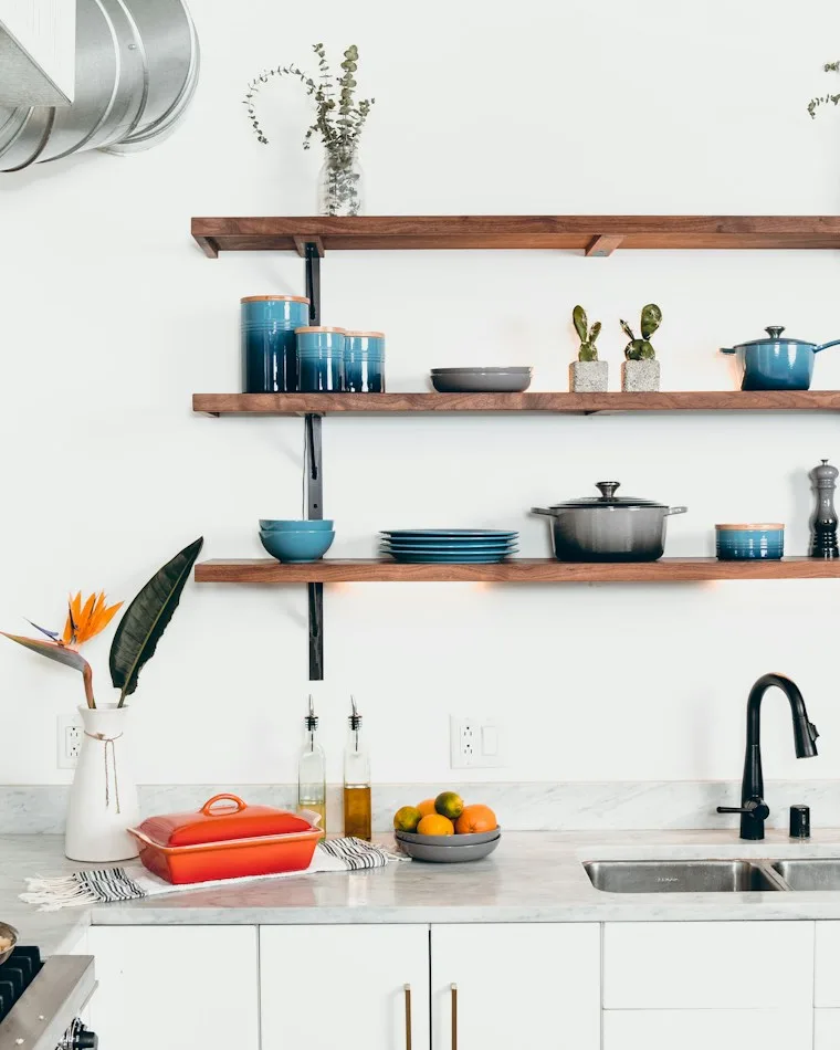 Blue ceramic plates and bowls standing in a dish rack