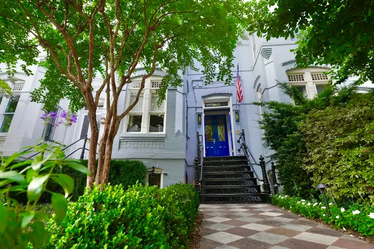 Charming house with a bright blue front door and a neat front walk