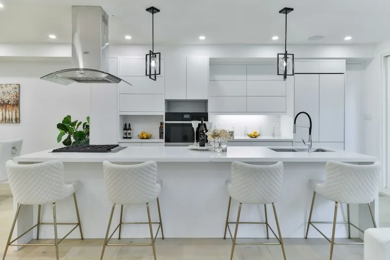 Kitchen with a center island and four bar stools
