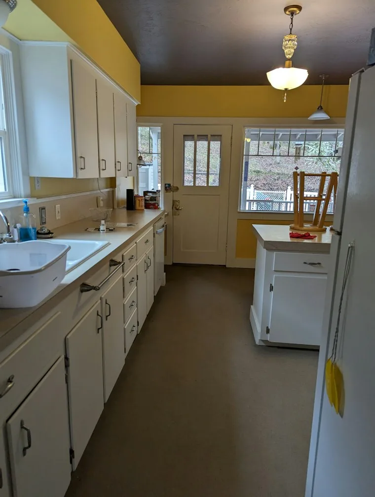Kitchen with a sink, cabinets and a white refrigerator