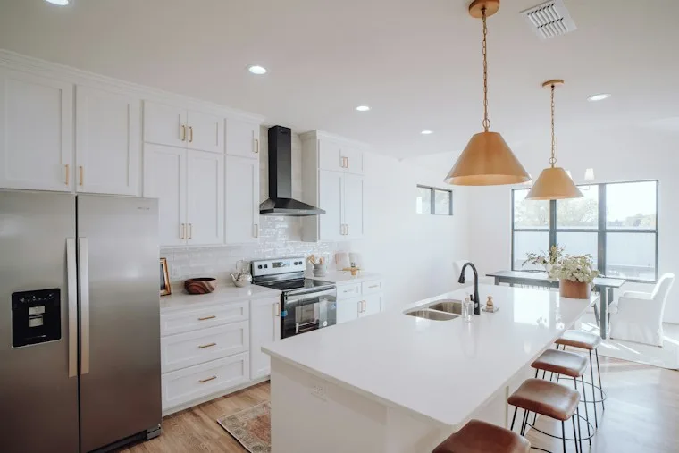 Kitchen with white cabinets and a silver French door refrigerator