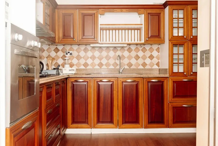 Kitchen with wooden cabinets and a stainless steel refrigerator