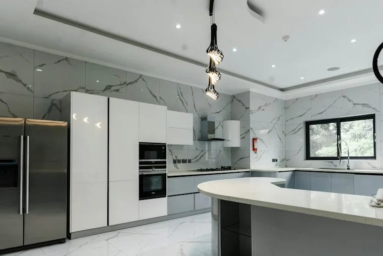 Modern kitchen with marble counters and stainless steel built-in appliances