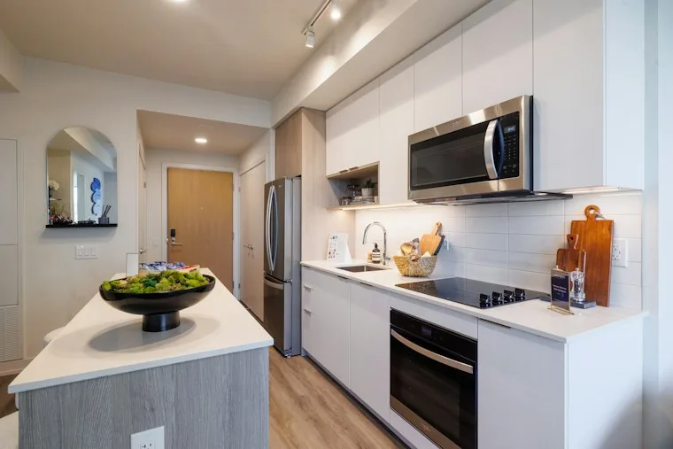 Modern kitchen with stainless steel appliances and an island, common in Morrisville townhomes