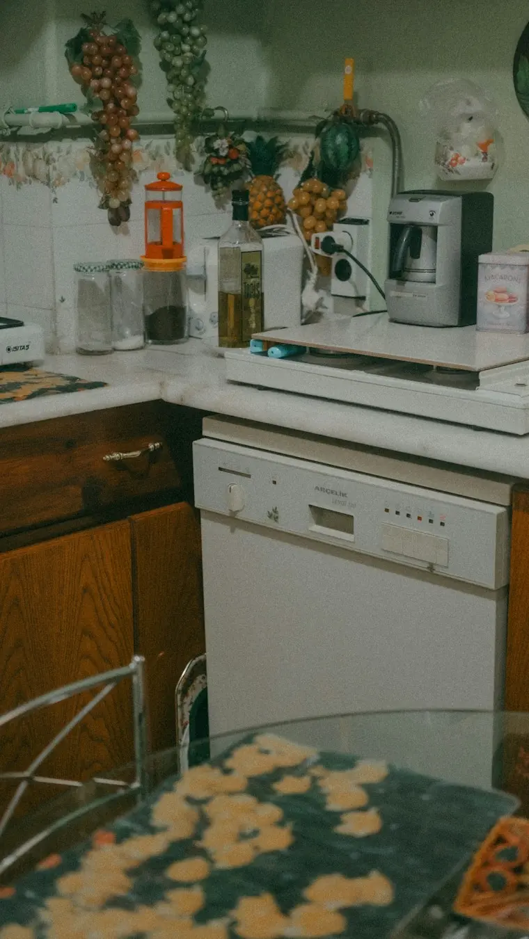 Older home kitchen with a stove, microwave and gray cabinets