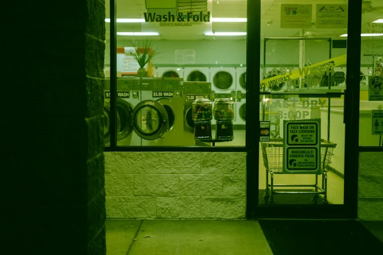 Pair of white front-load washing machines side by side