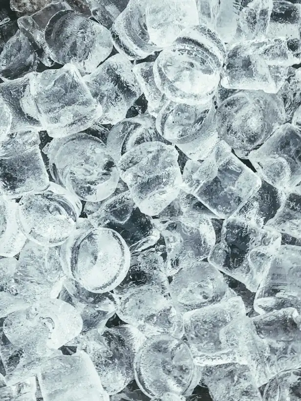 Pile of clear ice cubes with light shining through them