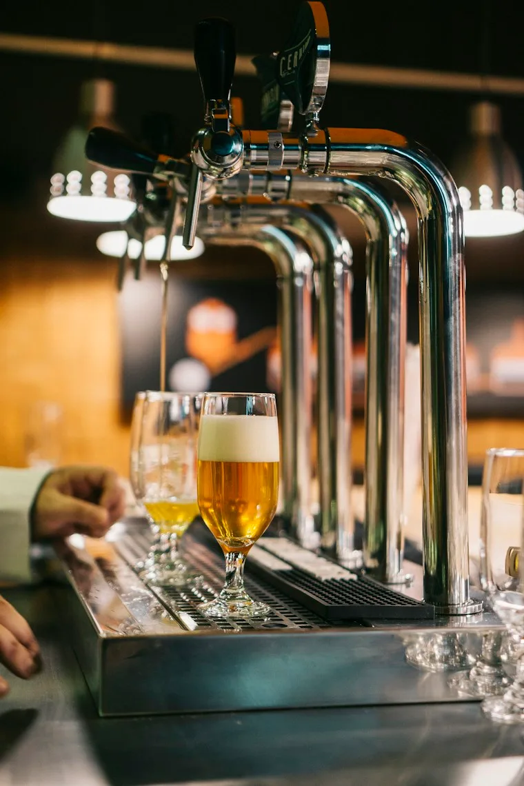 Row of shiny beer tap handles on a draft dispenser