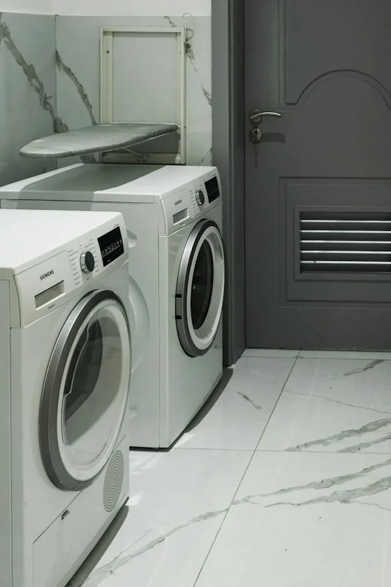 Side-by-side washer and dryer in a home laundry room