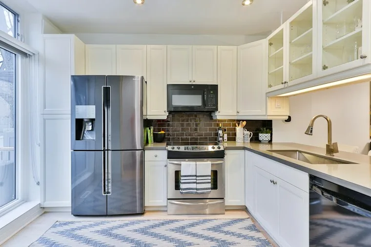 Stainless French door refrigerator in a white kitchen, ready for repair in Apex NC