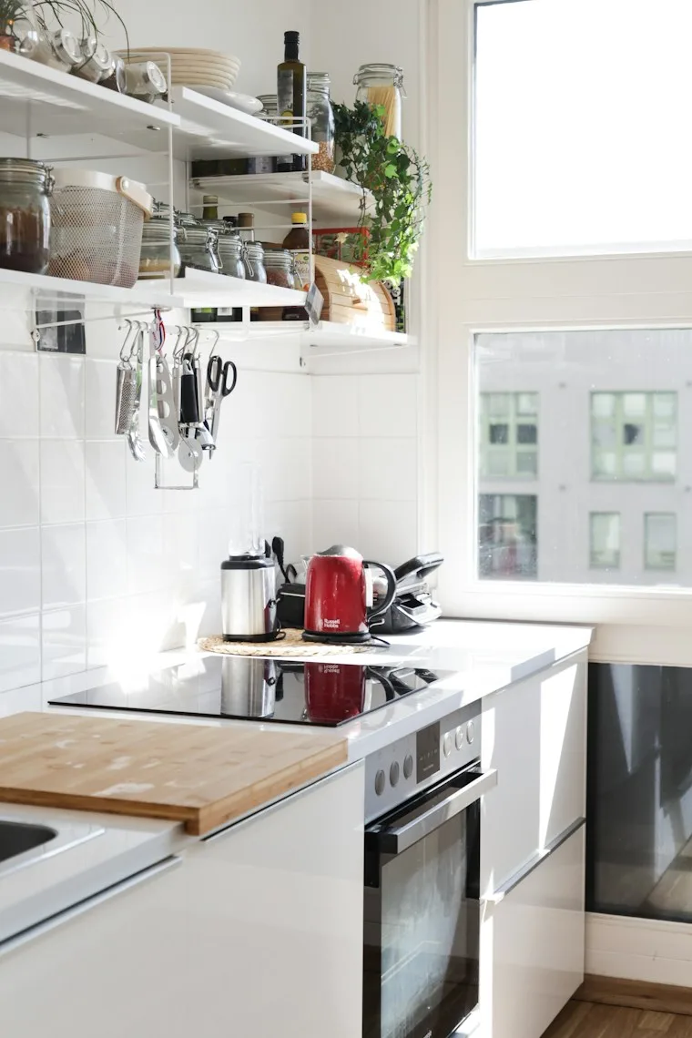 White kitchen cabinets with a sink in a clean, modern kitchen