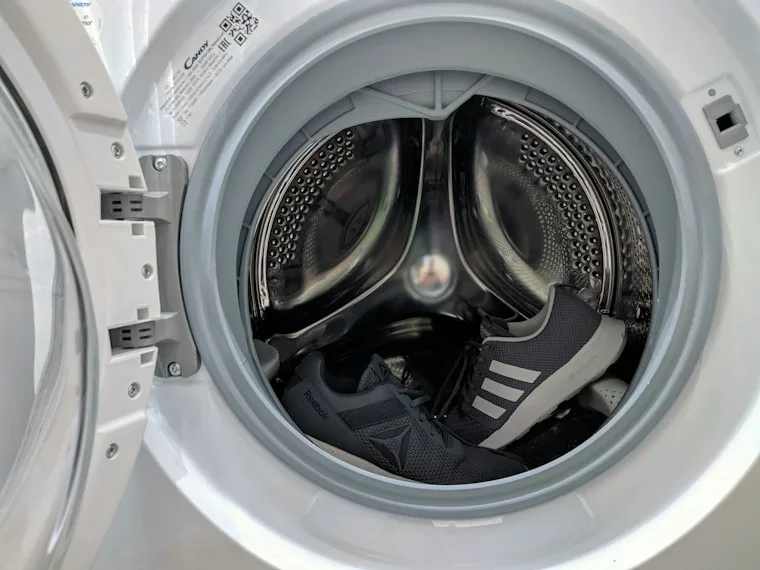 White washing machine standing in a bright laundry space